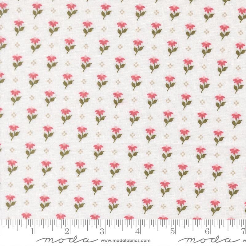 a repeating pattern of pink flowers on a white background, with a ruler for scale at the bottom.
