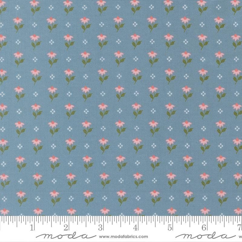 a repeating pattern of pink flowers on a blue background, with small white dots scattered throughout.