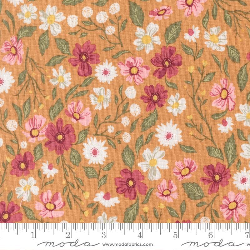 The image is a fabric with a floral pattern of various flowers and leaves in shades of pink, white, and orange.
