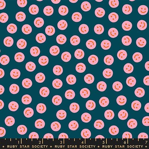 a pattern of pink smiley faces on a dark blue background.