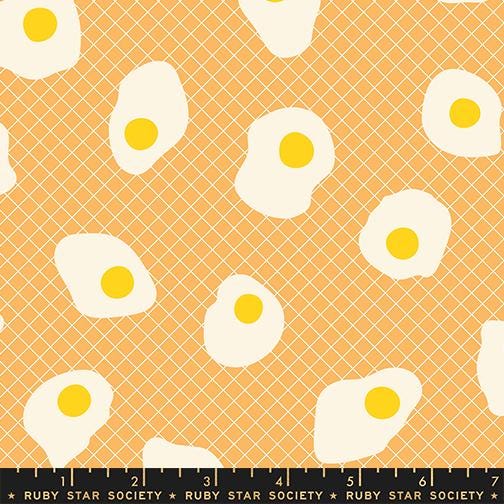 a pattern of white eggs with yellow yolks against a light orange background.
