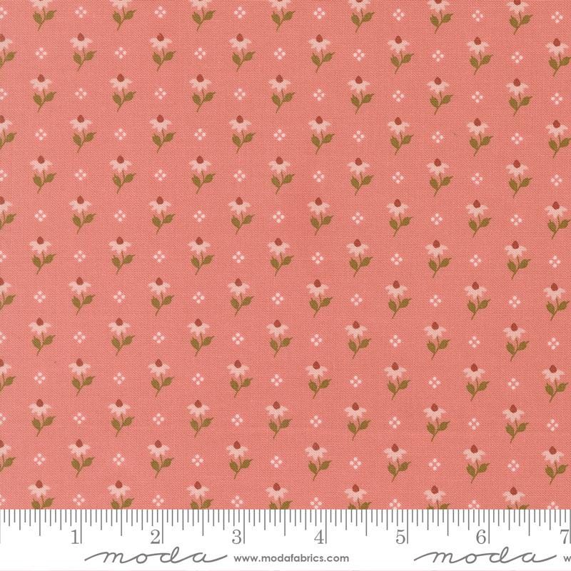a repeating pattern of pink flowers with green leaves on a fabric surface.