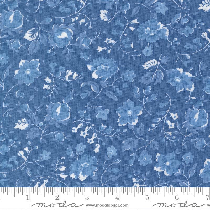 The image is a close-up of a fabric with a blue floral pattern.