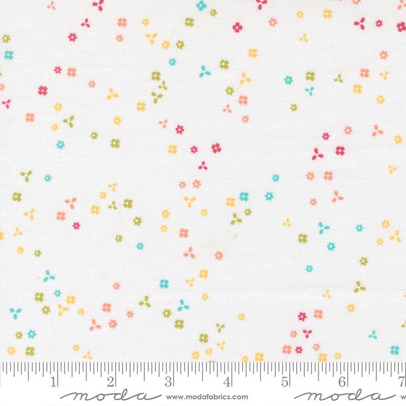 The image is a fabric with a pattern of small colorful flowers scattered across it.