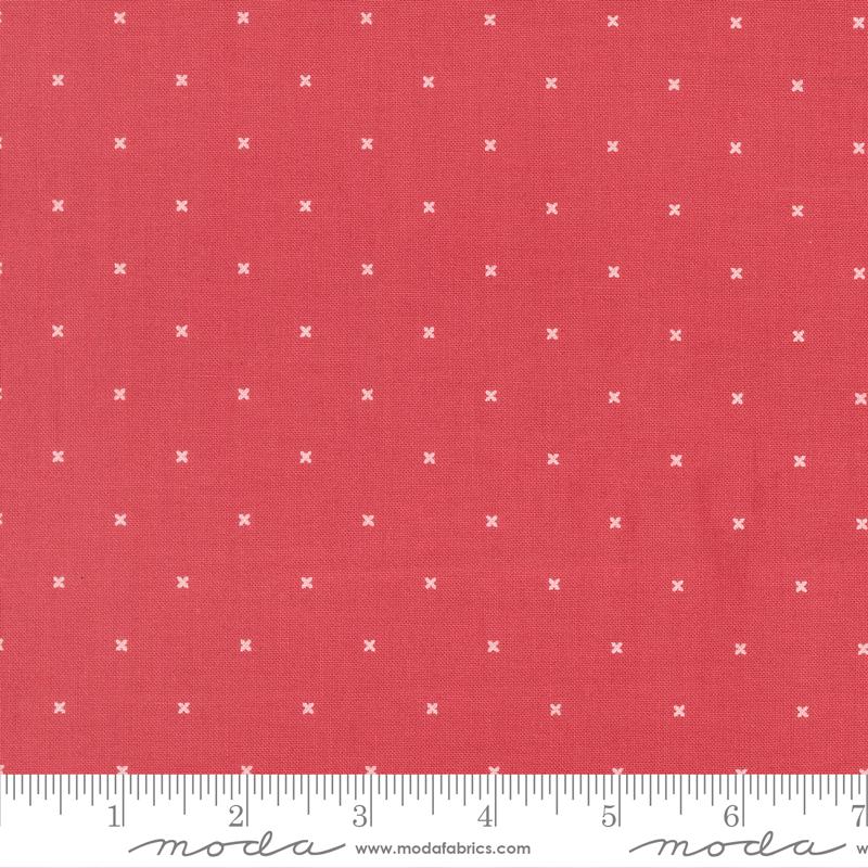 The image is a close-up of a red fabric with white crosses on it.
