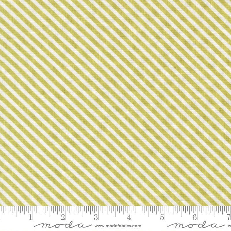 a repeating diagonal pattern of yellow and white stripes, with a ruler indicating the size of the fabric.