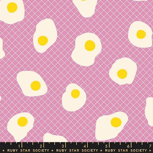 a pattern of white and yellow egg shapes against a pink background.