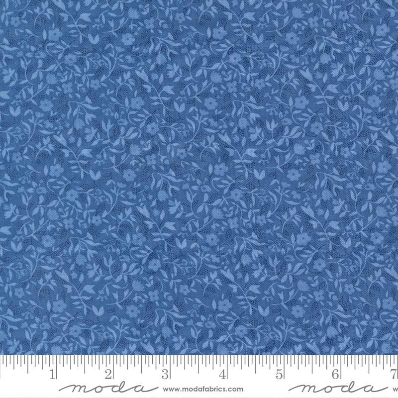 The image is a close-up of a fabric with a blue floral pattern.