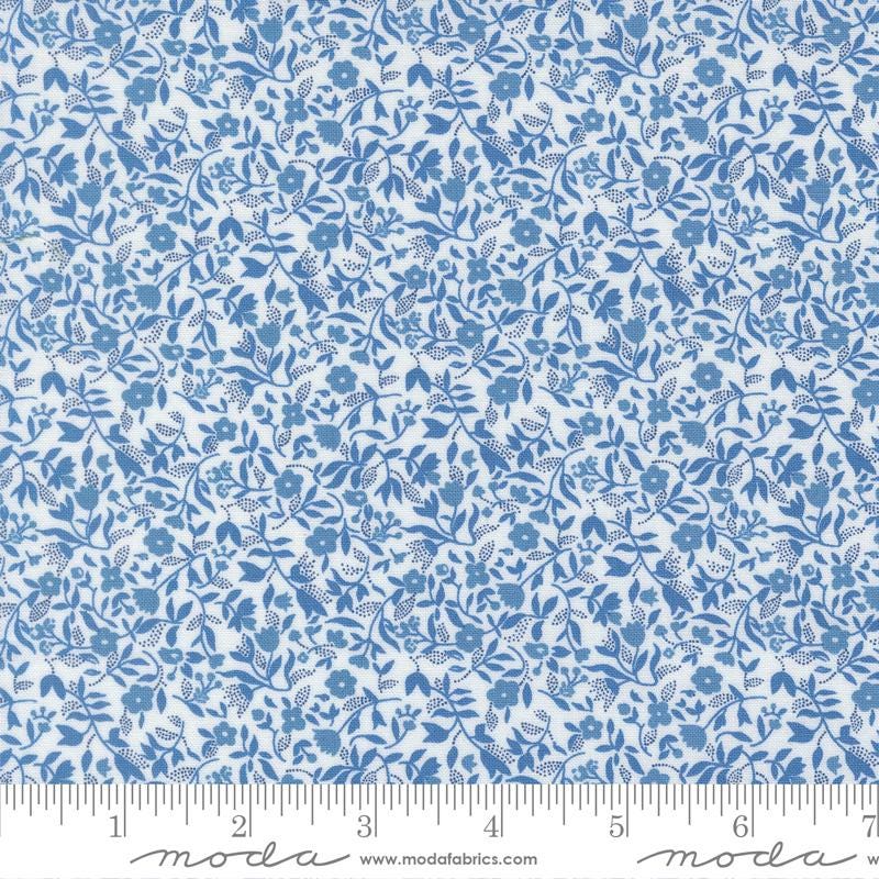 The image is a close-up of a fabric with a blue floral pattern.