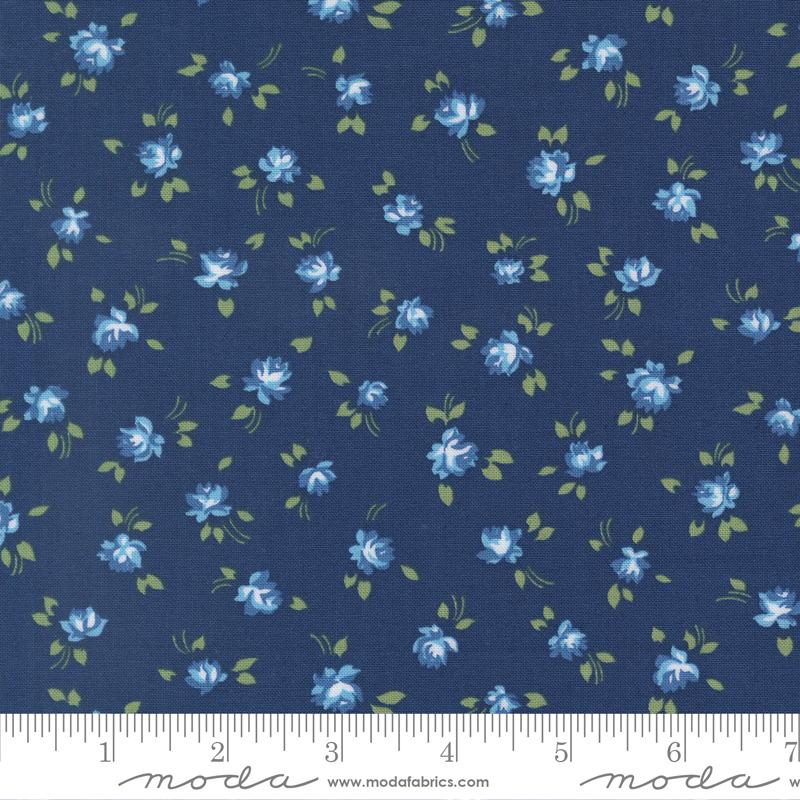 a fabric with a repeating pattern of blue flowers and green leaves on a dark blue background.
