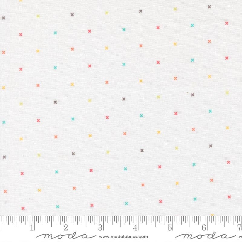 a white background with numerous small, colorful crosses scattered across it. There is a ruler at the bottom of the image, indicating the size of the crosses in millimeters.