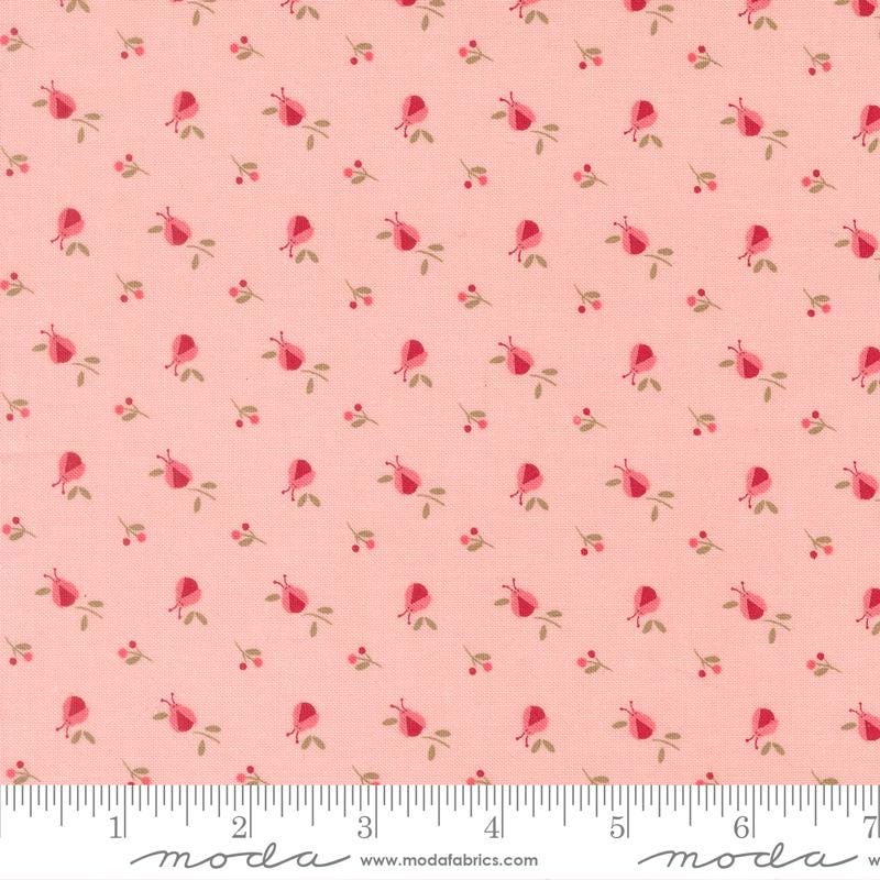 a repeating pattern of pink flowers and leaves on a fabric surface.