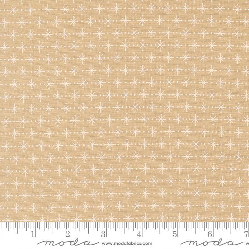 a fabric with a repeating pattern of white snowflakes on a beige background.