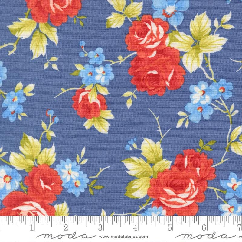 a fabric with a floral pattern of red roses and blue flowers against a blue background.