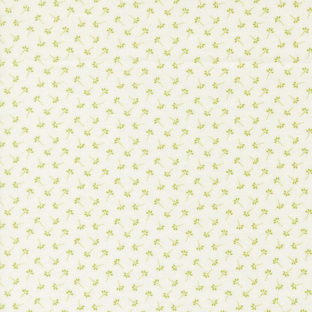 a repeating pattern of small green flowers or leaves on a light-colored background.