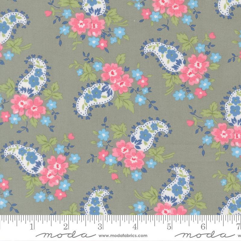 a repeating pattern of paisley designs with pink and blue flowers on a grey background.