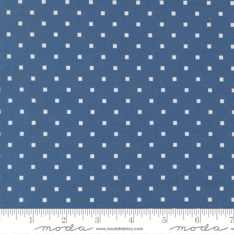 a close-up view of a fabric with a blue background and white polka dots. The fabric appears to be a type of material with a dotted pattern, possibly used for clothing or home decor.
