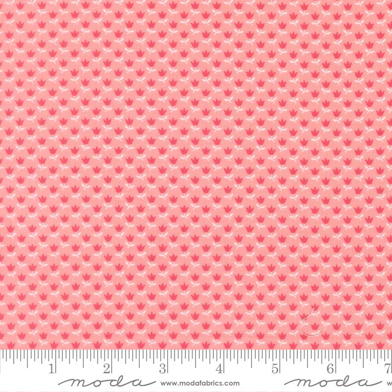 a repeating pattern of pink flowers on a fabric surface.