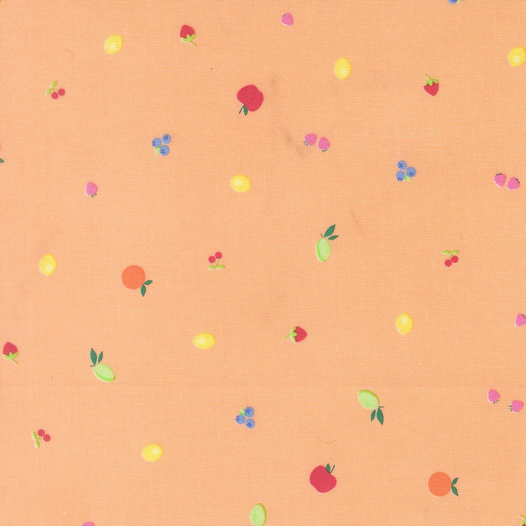 a pattern of various fruits, including apples, oranges, and cherries, scattered across a peach-colored background.