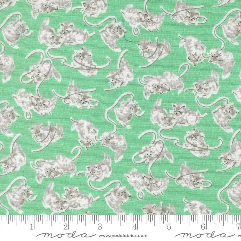 a repeating pattern of gray cats on a green background.
