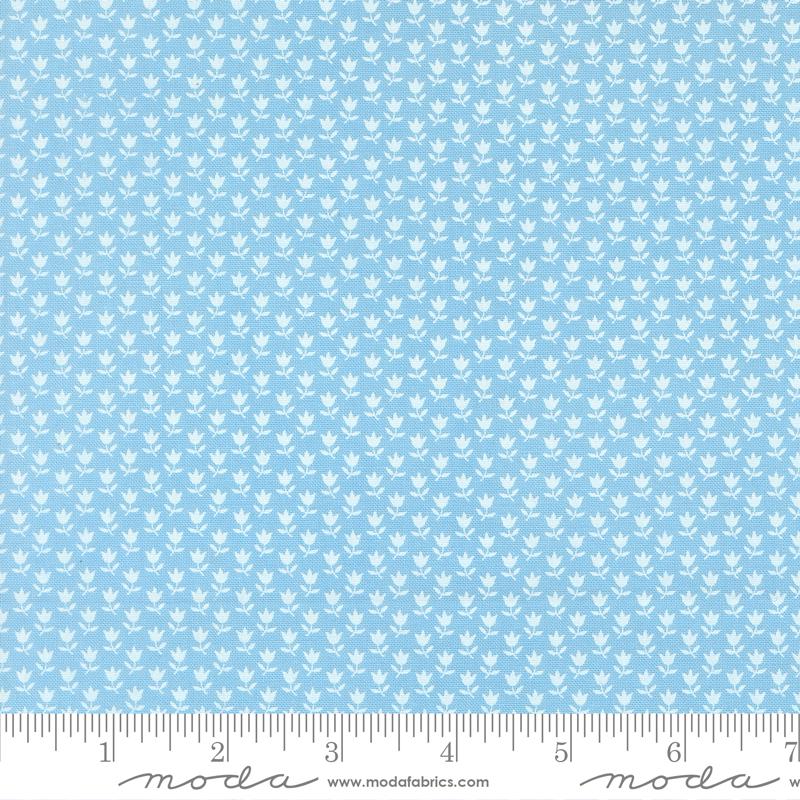 The image is a fabric with a repeating pattern of small white flowers or leaves. The pattern is evenly spaced and covers the entire fabric, creating a uniform and visually appealing design.