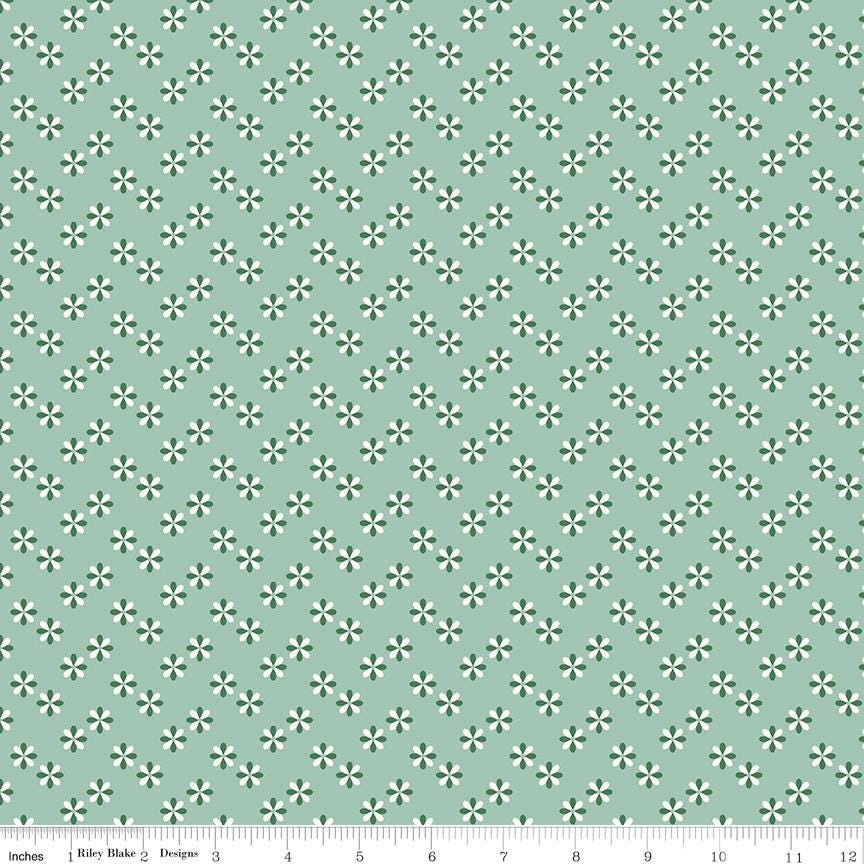 a repeating pattern of small green and white flowers on a light green background.