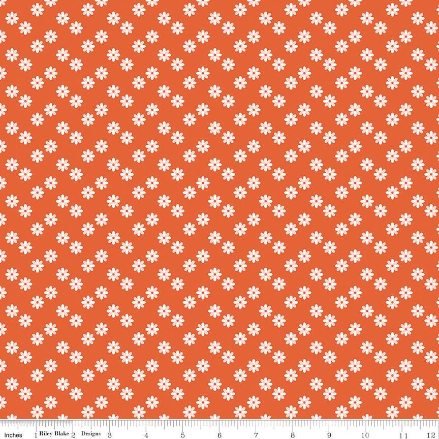 a repeating pattern of small white flowers against a bright orange background.