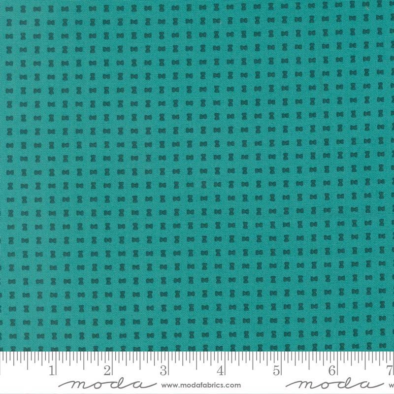 The image is a close-up of a fabric with a grid-like pattern of small black dots or squares, creating a textured appearance.