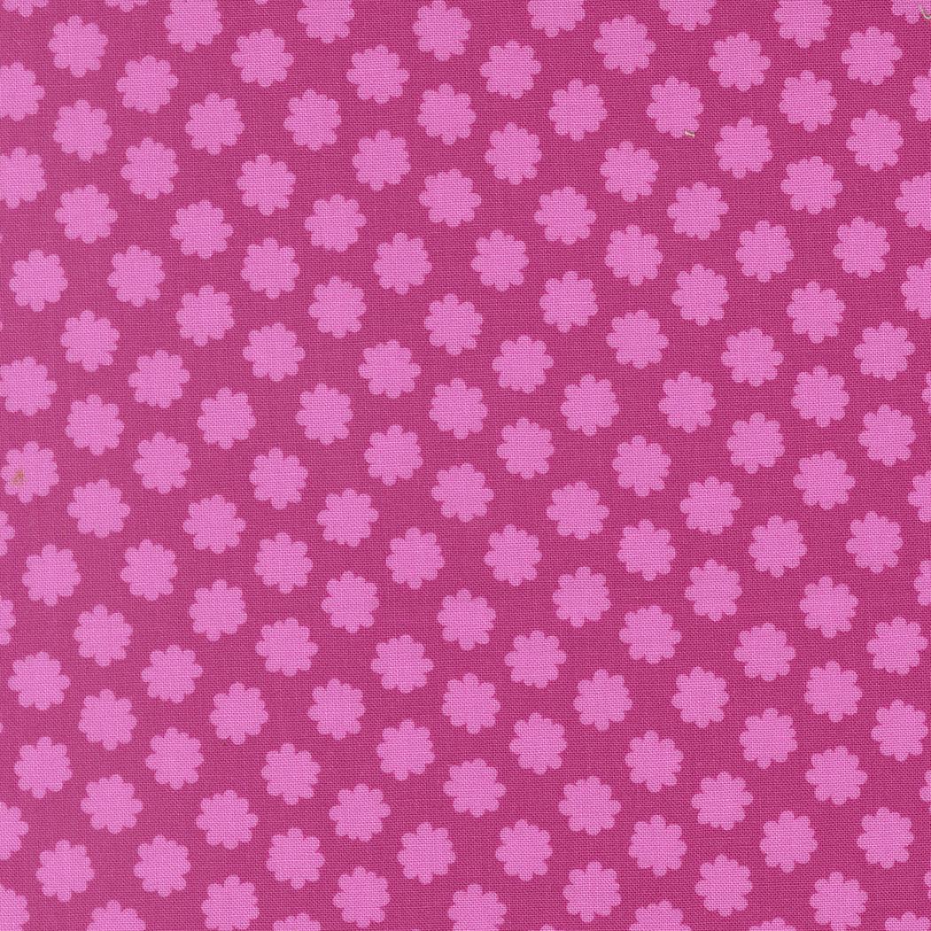 a repeating pattern of pink flowers on a purple background.