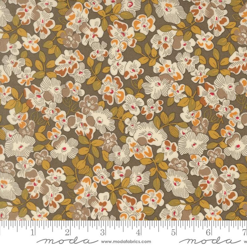 The image is a close-up of a fabric with a floral pattern, featuring various shades of brown and orange flowers and leaves.