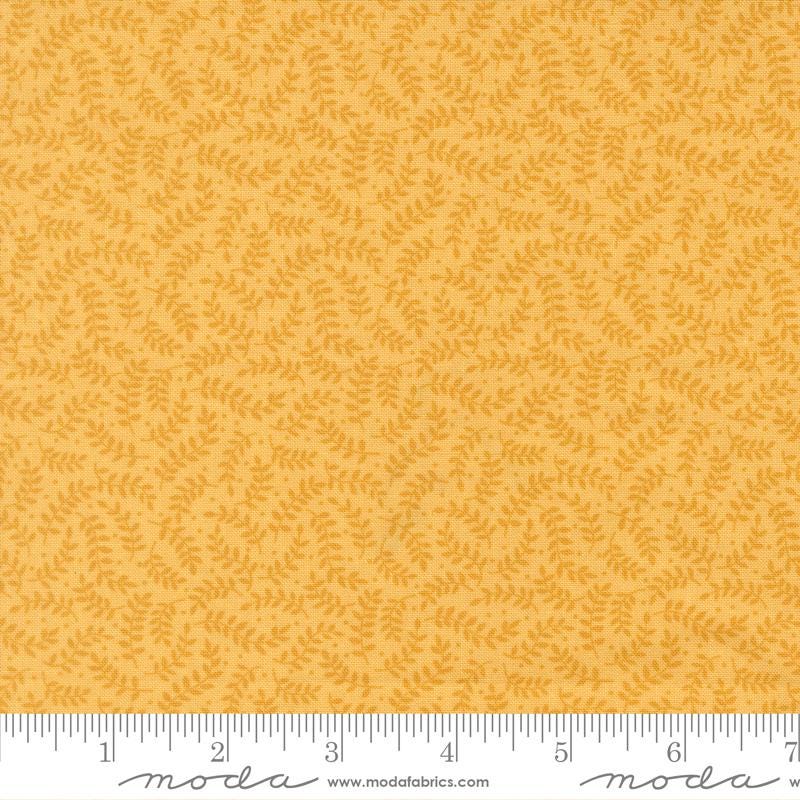 a fabric with a repeating pattern of yellow leaves on a yellow background.