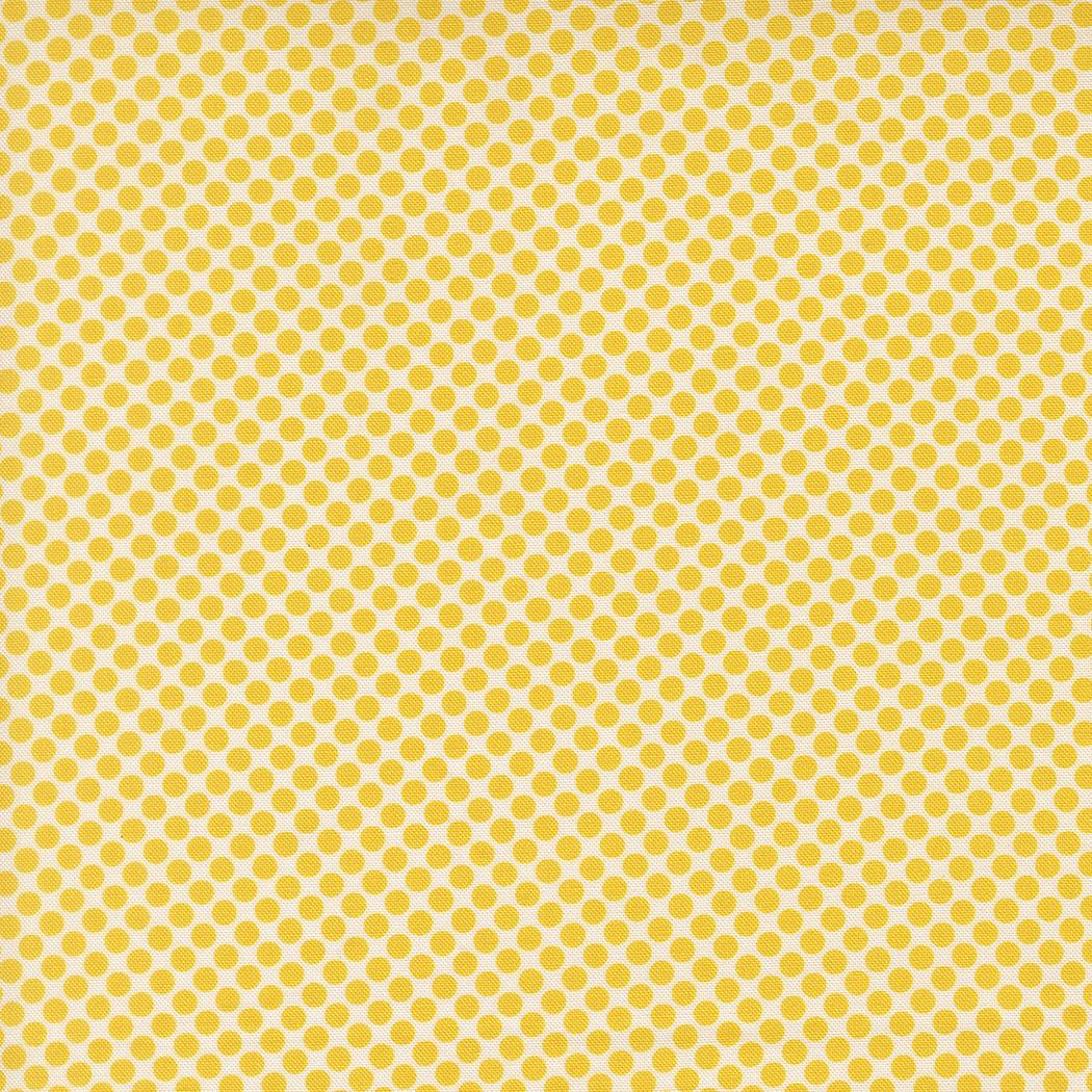 a repeating pattern of yellow polka dots on a yellow background.