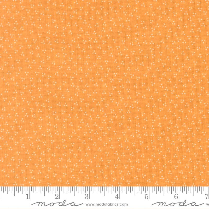 The image is a close-up of a fabric with a small white dot pattern, and it is described as a fabric with a small white dot pattern.