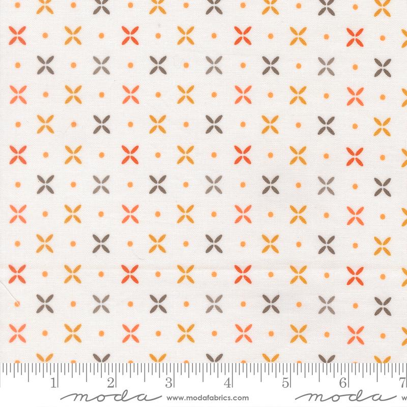 a fabric with a repeating pattern of orange and gray flowers, with small orange dots scattered throughout the fabric.