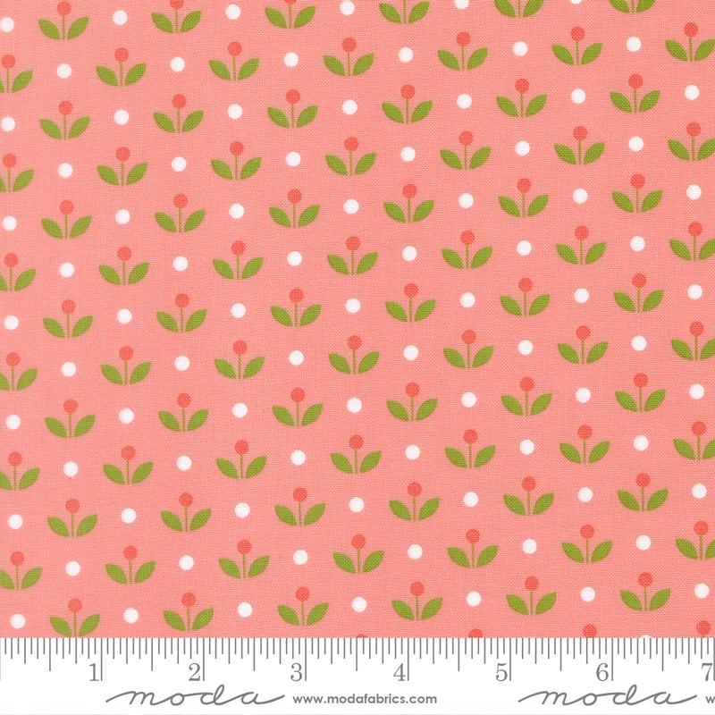 a repeating pattern of green leaves and red flowers on a pink background, with white polka dots scattered throughout.