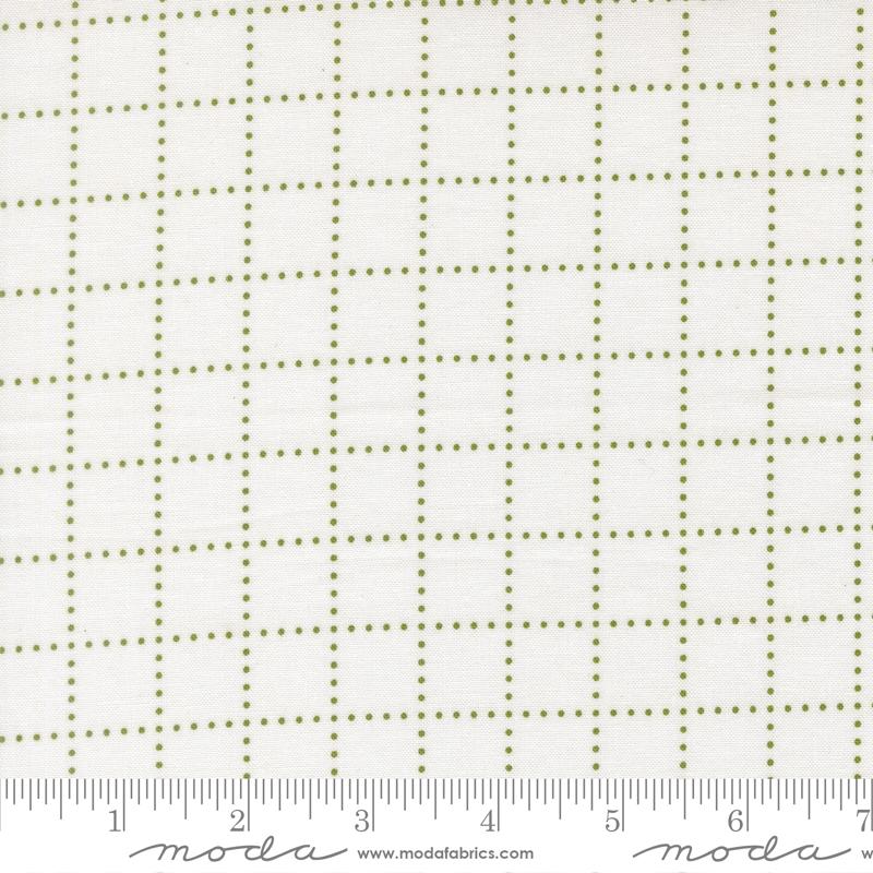 The image is a close-up of a fabric with a grid pattern of small green dots arranged in a grid-like design.