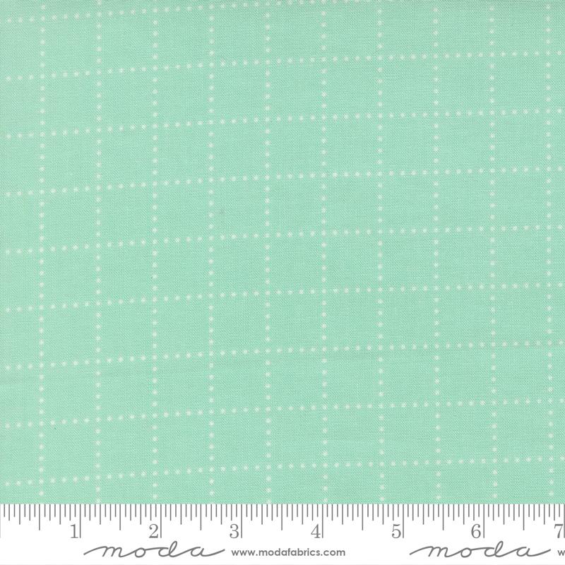 The image is a fabric with a grid pattern of small white dots or stars, creating a mint green or light green color.