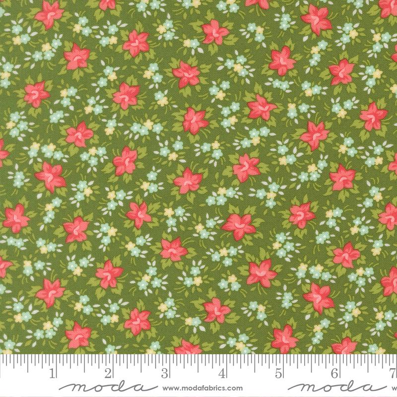 The image is a fabric with a floral pattern of red flowers and green leaves. The pattern is repeated across the fabric, creating a visually appealing and colorful design.