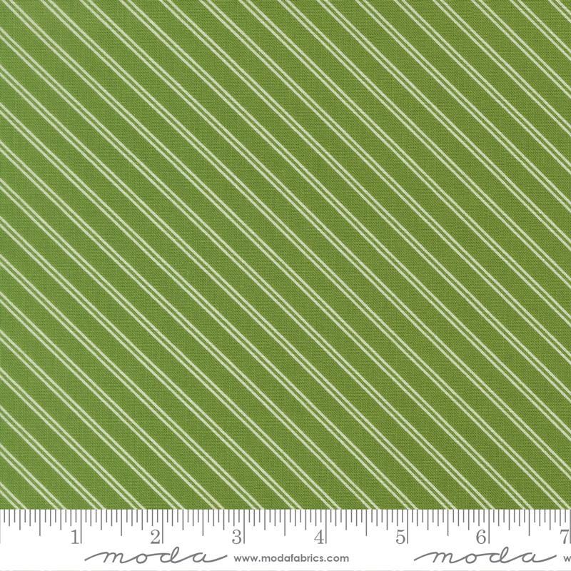 a close-up view of a fabric with a diagonal green stripe pattern. The fabric appears to be made of a material with a striped texture, and the image is described in terms of its size and the website Moda Fabrics.com.