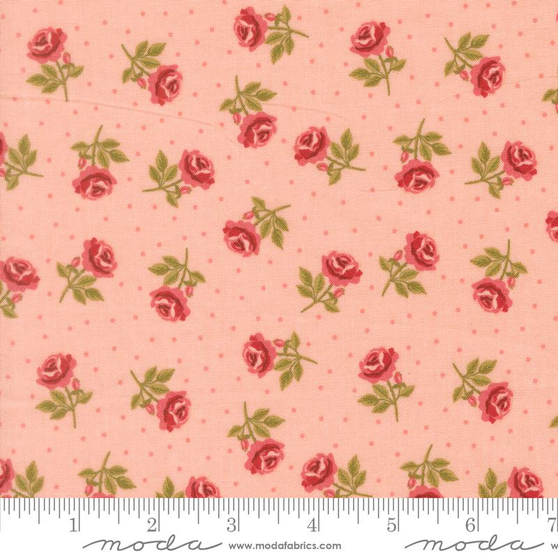 a fabric with a repeating pattern of red roses and green leaves against a light pink background.
