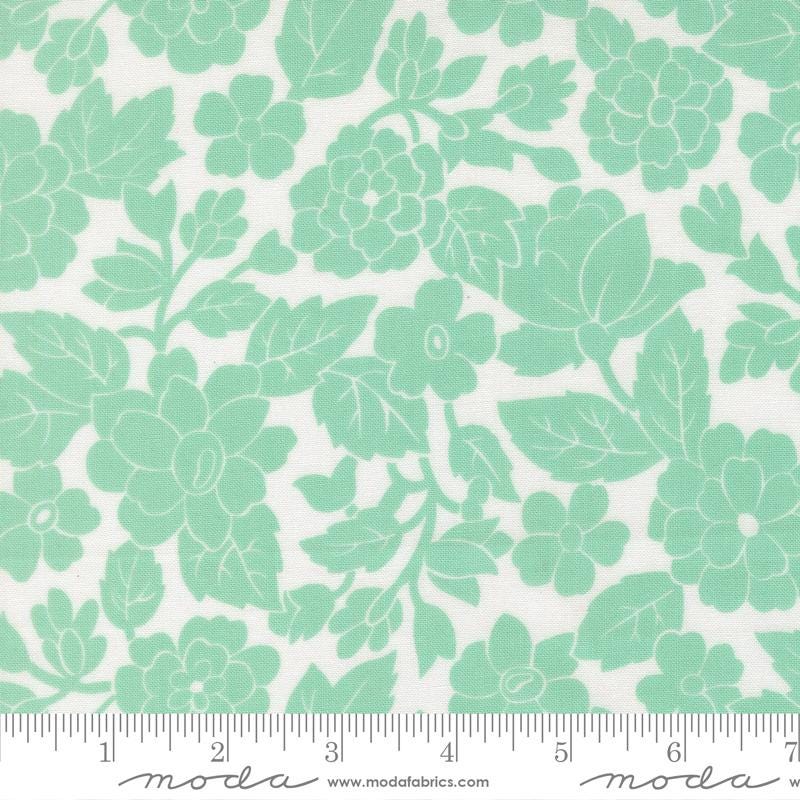 a repeating pattern of green floral designs on a white background.