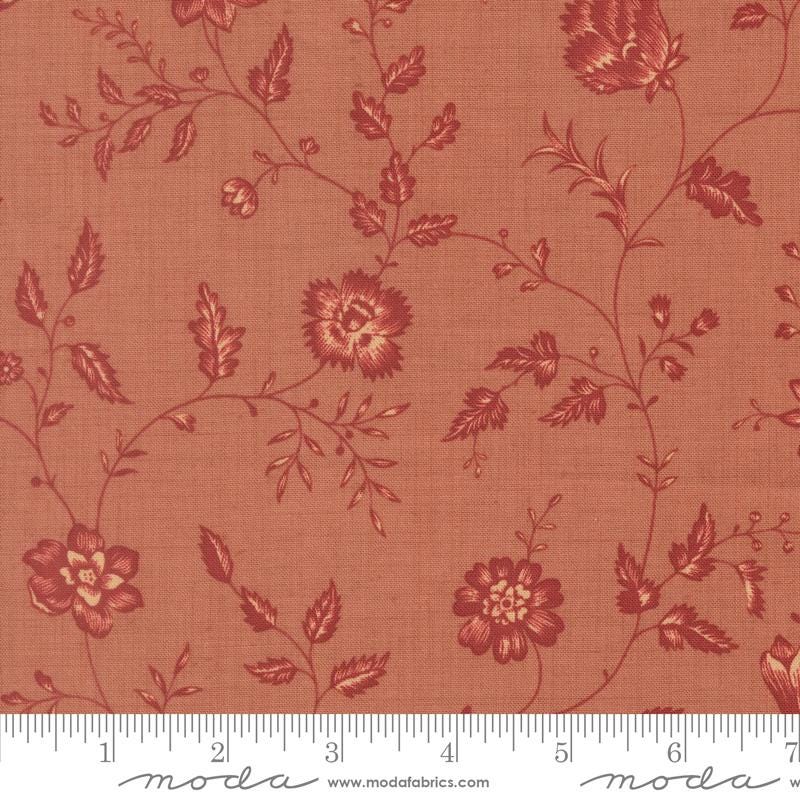 a fabric with a floral pattern in shades of red and orange. The pattern consists of various flowers and leaves, creating a visually appealing and intricate design. The fabric appears to be made of a soft, textured material, suitable for clothing or home decor.