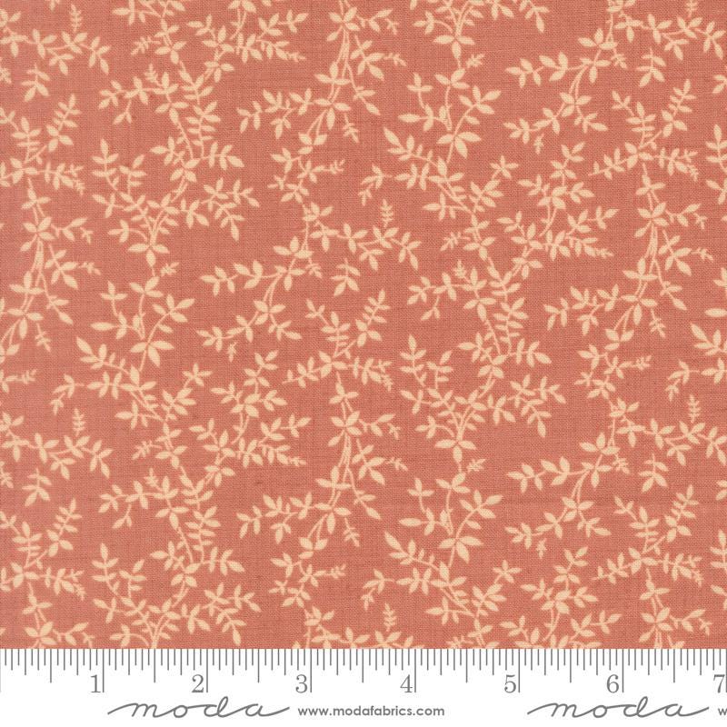 a fabric with a repeating pattern of leaves and branches in shades of orange and beige. The pattern is printed on the fabric, creating a visually appealing and textured design.