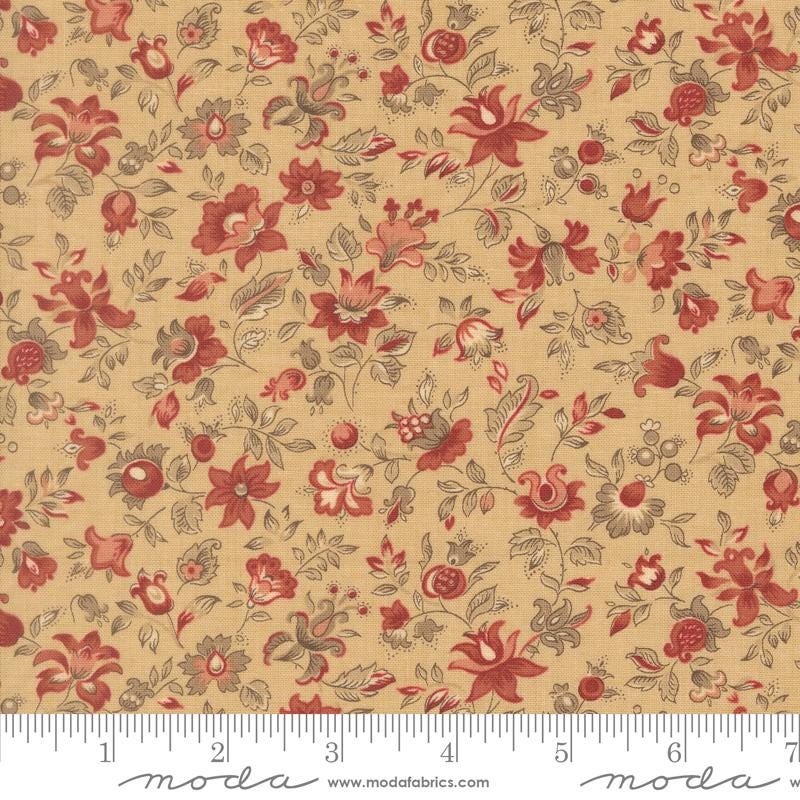 The image is a fabric with a floral pattern in shades of red and beige. The pattern consists of various flowers and leaves, creating a visually appealing and intricate design. The fabric appears to be made of a material that resembles cotton or linen, and it is displayed on a ruler for scale.