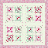 a pink and green quilt with a pink border