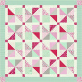 a pink and green quilt with triangles on it