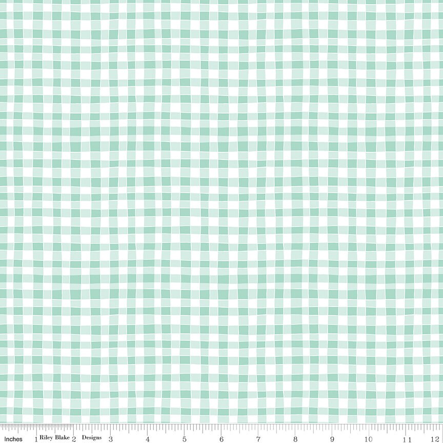 a green and white checkered fabric with a ruler