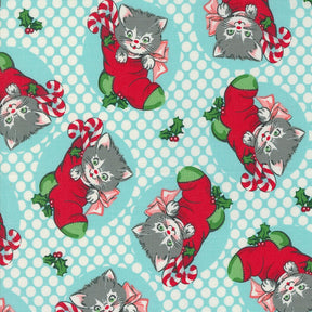 a blue and white background with a cat wearing a santa hat