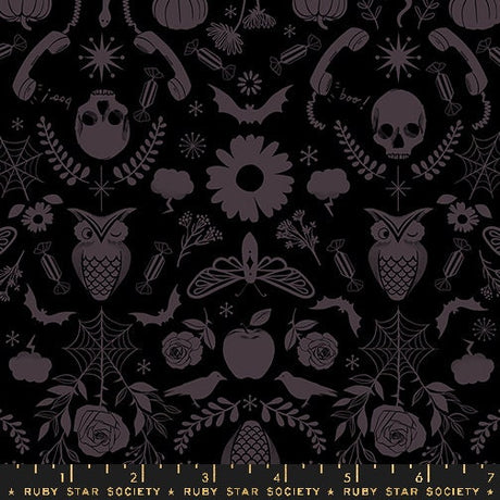 a black and white pattern with skulls and flowers