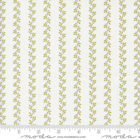 a white and green striped fabric with leaves on it